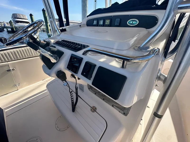 Slide: The Image of 2008 Grady-White Bimini 306 boat console with steering wheel and controls. - 18