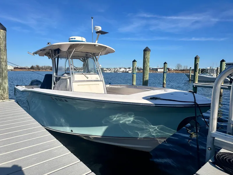 Slide: The Image of 2008 Grady-White Bimini 306 boat docked at marina under clear blue sky. - 2