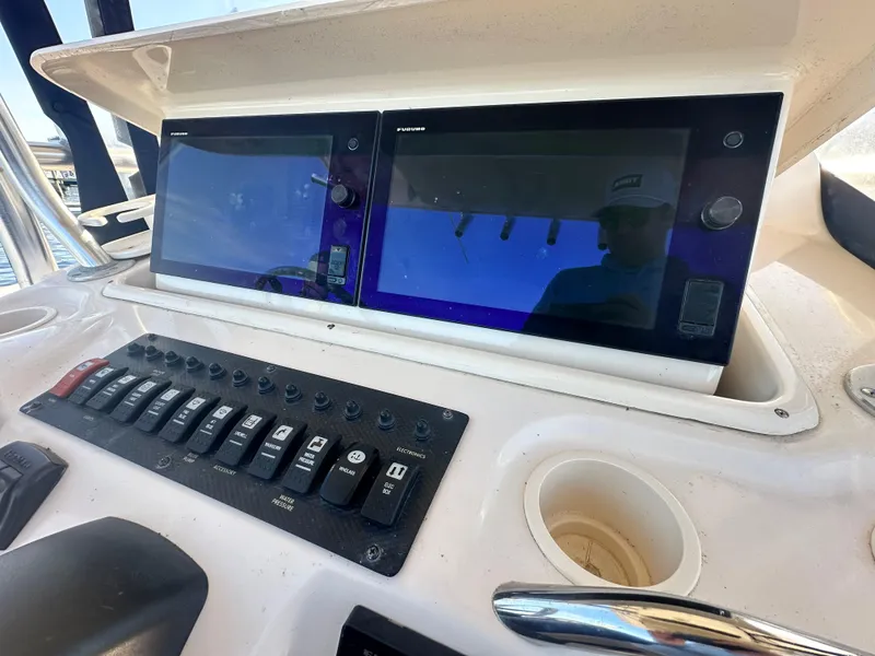 Slide: The Image of Control panel of 2008 Grady-White Bimini 306 boat with dual screens and switches. - 20