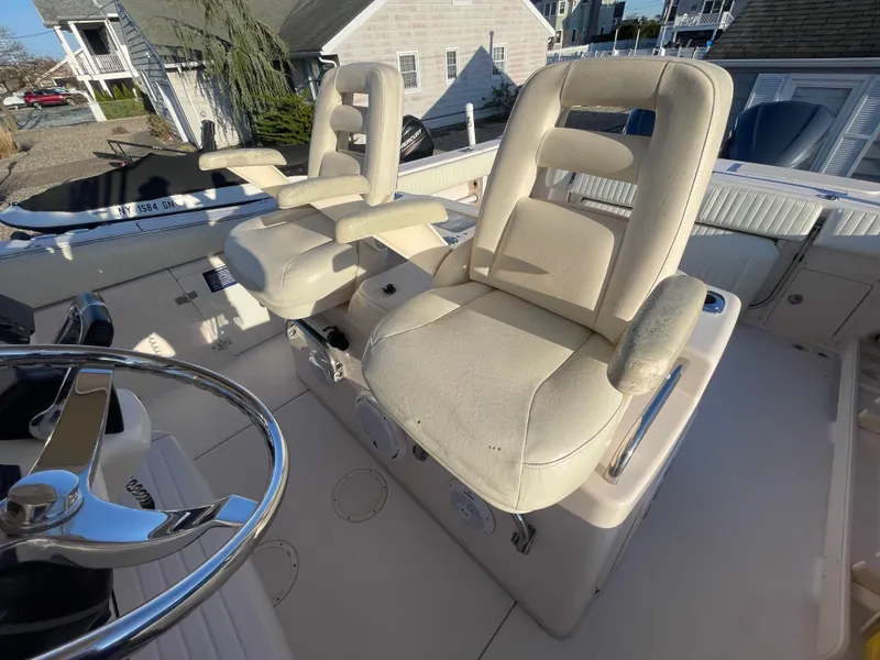 Slide: The Image of 2008 Grady-White Bimini 306 boat interior with dual captain's chairs and steering wheel. - 26
