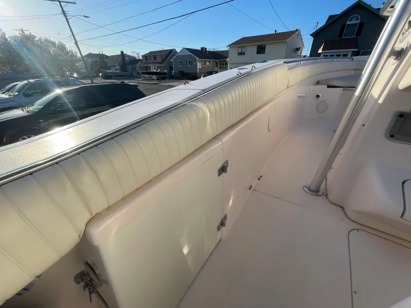 Slide: The Image of 2008 Grady-White Bimini 306 boat interior with cushioned seating and storage compartments. - 29