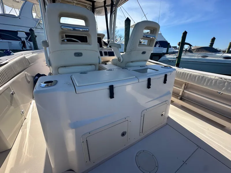 Slide: The Image of 2008 Grady-White Bimini 306 boat interior with dual seats and storage compartments. - 31