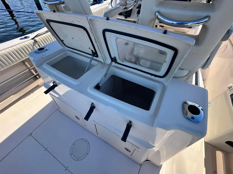 Slide: The Image of 2008 Grady-White Bimini 306 boat with open storage compartments on deck. - 32