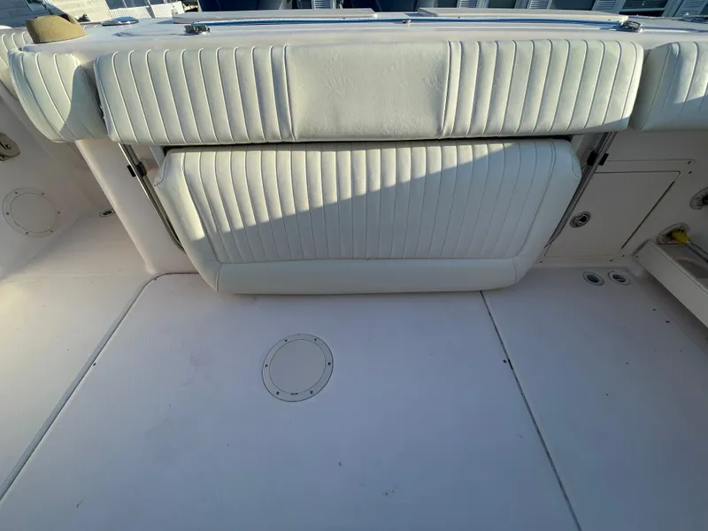Slide: The Image of 2008 Grady-White Bimini 306 boat interior with white cushioned seating and deck. - 33