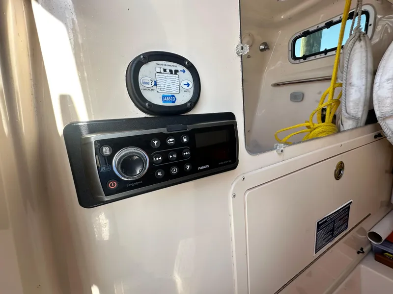 Slide: The Image of 2008 Grady-White Bimini 306 interior with control panel and storage compartment. - 35