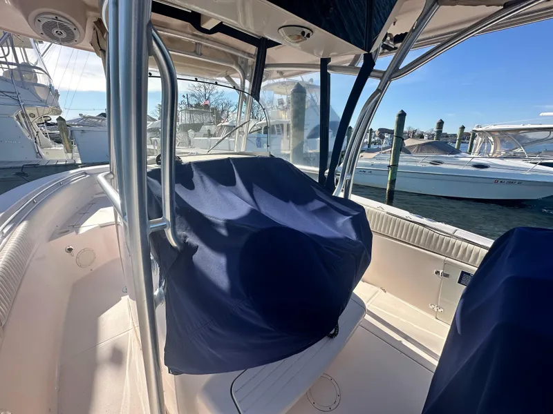 Slide: The Image of 2008 Grady-White Bimini 306 boat interior with covered console, docked at marina. - 37