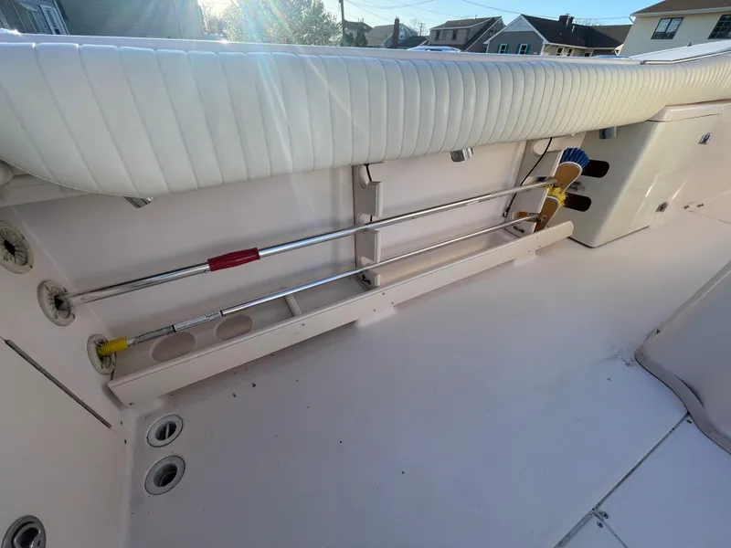 Slide: The Image of 2008 Grady-White Bimini 306 boat interior with storage compartments and cleaning tools. - 39