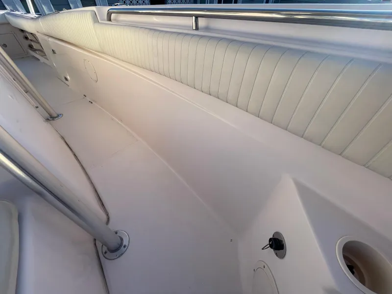 Slide: The Image of 2008 Grady-White Bimini 306 boat interior with white cushioned seating and stainless steel railings. - 40