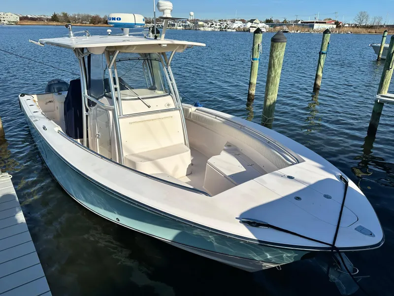 Slide: The Image of 2008 Grady-White Bimini 306 boat docked in calm marina waters. - 5