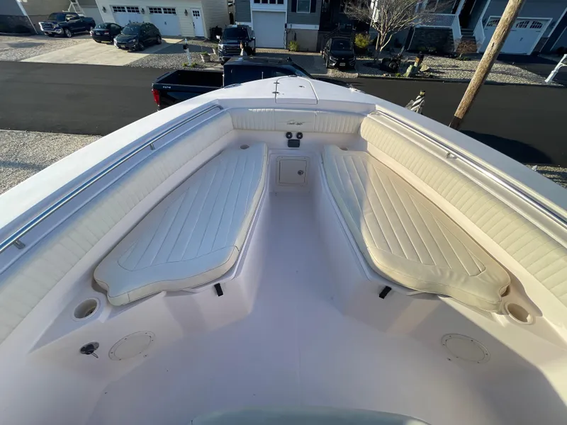 Slide: The Image of 2008 Grady-White Bimini 306 boat interior with cushioned seating and storage compartments. - 7