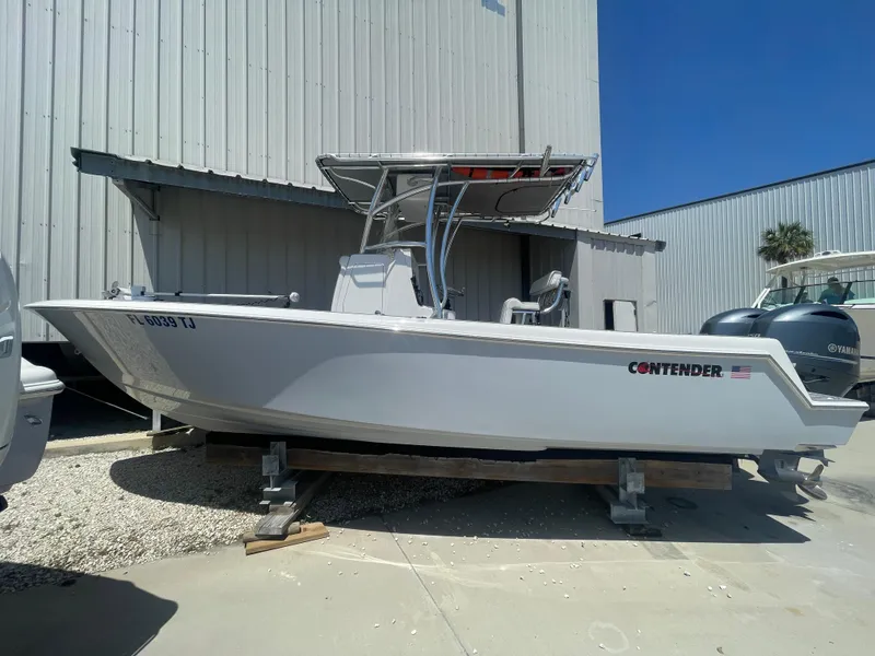 Slide: The Image of 2022 Contender 25 Tournament boat on display outside a warehouse. - 0