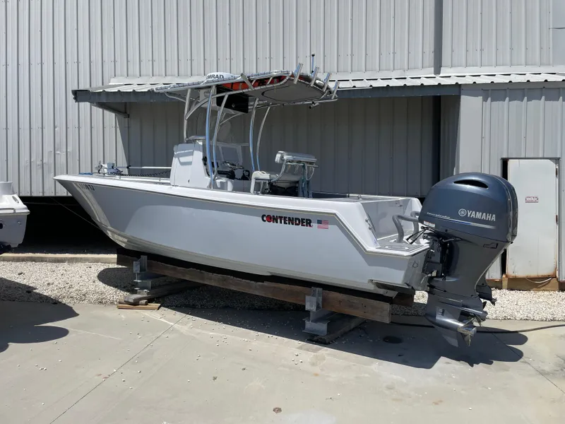 Slide: The Image of 2022 Contender 25 Tournament boat with Yamaha outboard motor, docked outdoors. - 1
