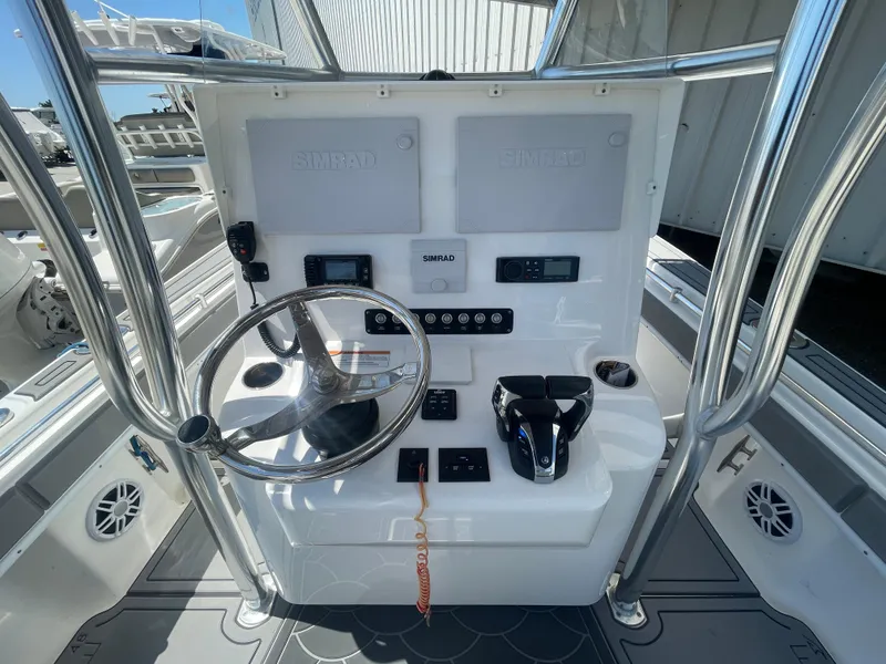 Slide: The Image of 2022 Contender 25 Tournament boat console with steering wheel and controls. - 10