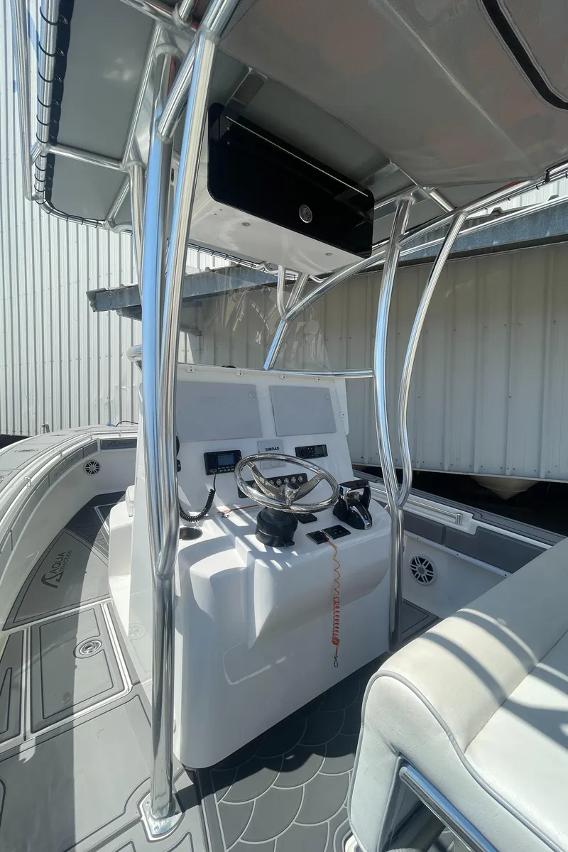 Slide: The Image of 2022 Contender 25 Tournament boat interior with steering console and seating. - 11
