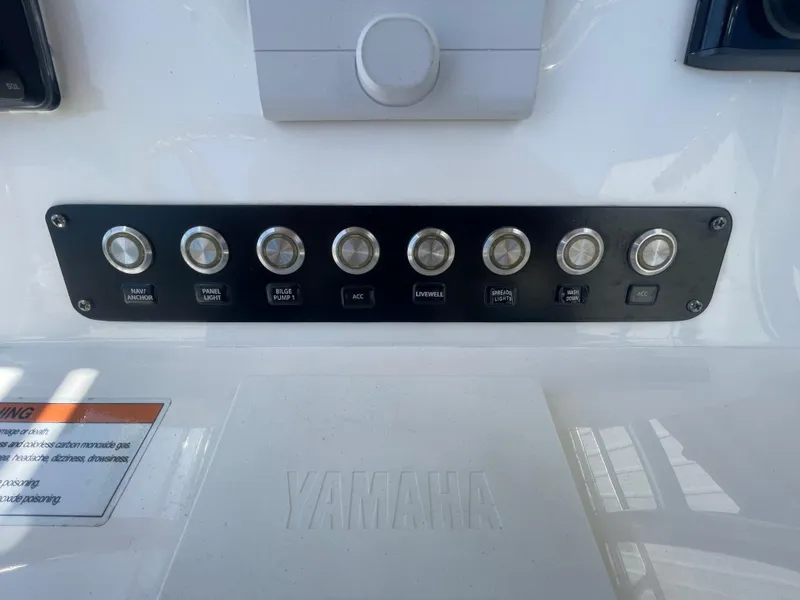 Slide: The Image of Control panel of a 2022 Contender 25 Tournament boat with Yamaha branding. - 12
