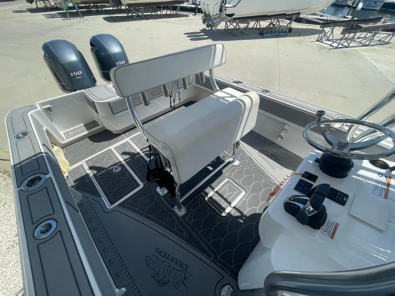 Slide: The Image of 2022 Contender 25 Tournament boat interior with dual engines and steering console. - 14