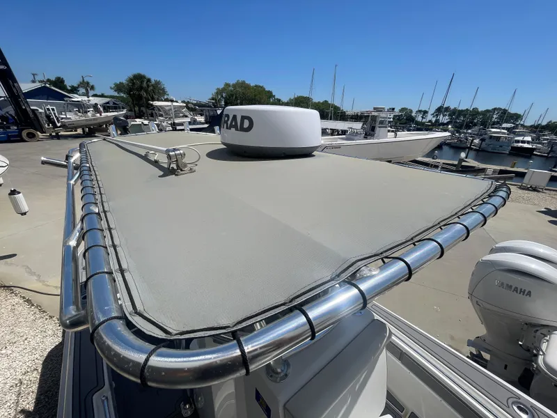 Slide: The Image of 2022 Contender 25 Tournament boat with radar, docked at a marina under clear blue skies. - 16