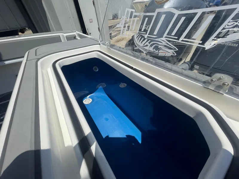 Slide: The Image of Livewell on 2022 Contender 25 Tournament boat, featuring a sleek design and blue interior. - 19