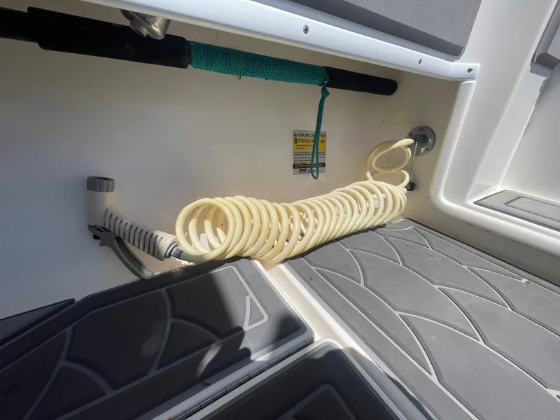 Slide: The Image of Coiled hose on 2022 Contender 25 Tournament boat deck, featuring non-slip flooring. - 21