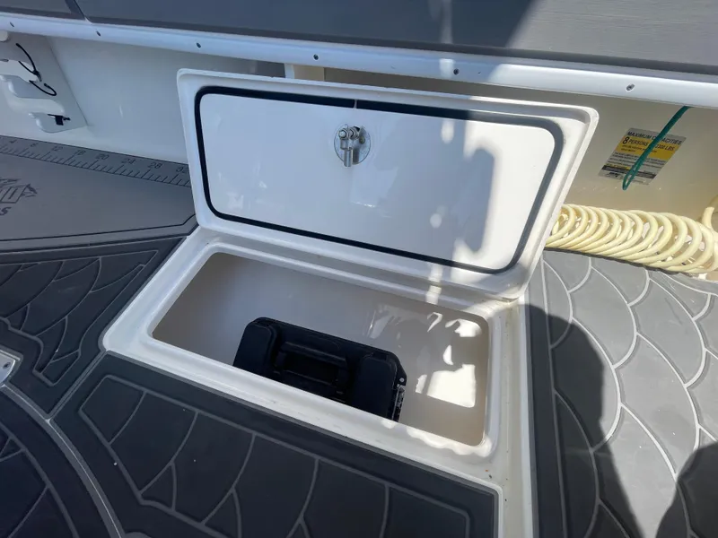 Slide: The Image of Open storage compartment on 2022 Contender 25 Tournament boat deck. - 24