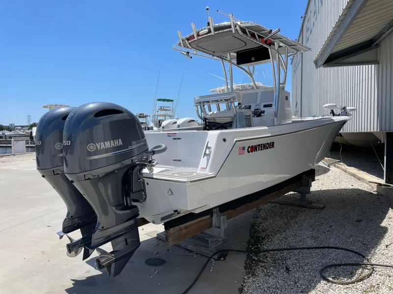 Slide: The Image of 2022 Contender 25 Tournament boat with Yamaha engines, docked outdoors. - 4