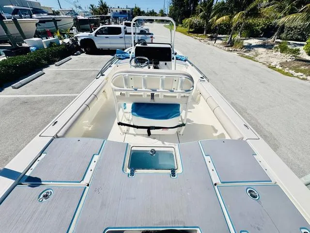 Slide: The Image of 2021 Sea Born FX24 boat in parking lot, showcasing spacious deck and seating. - 10