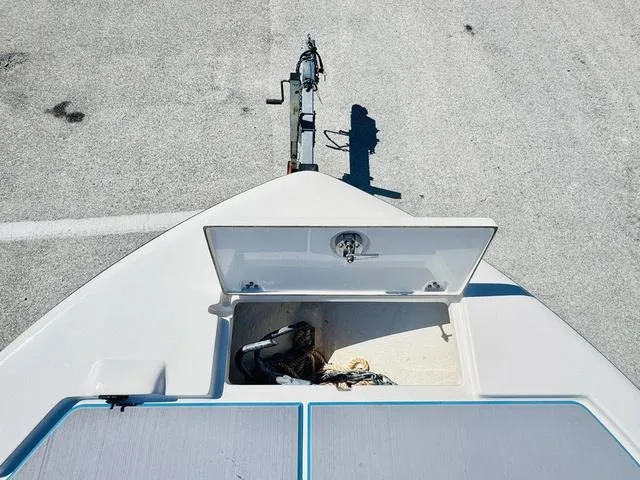 Slide: The Image of 2021 Sea Born FX24 boat with open anchor compartment on trailer. - 17