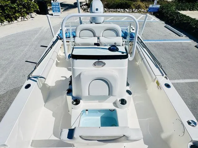 Slide: The Image of 2021 Sea Born FX24 boat interior with seating and console, parked in a lot. - 19