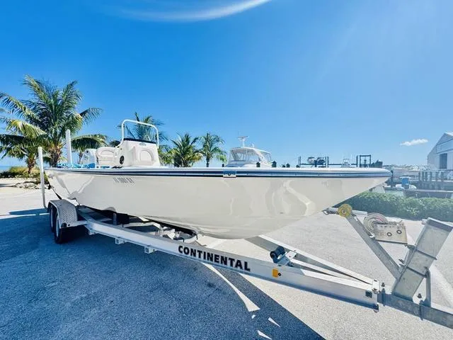 Slide: The Image of 2021 Sea Born FX24 boat on trailer, sunny day, palm trees in background. - 22