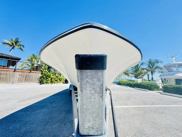 Slide: The Image of 2021 Sea Born FX24 boat on trailer, sunny day, palm trees in background. - 23