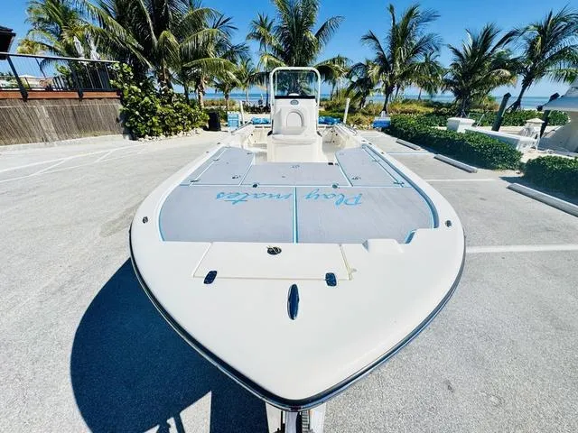 Slide: The Image of 2021 Sea Born FX24 boat parked near palm trees on a sunny day. - 24