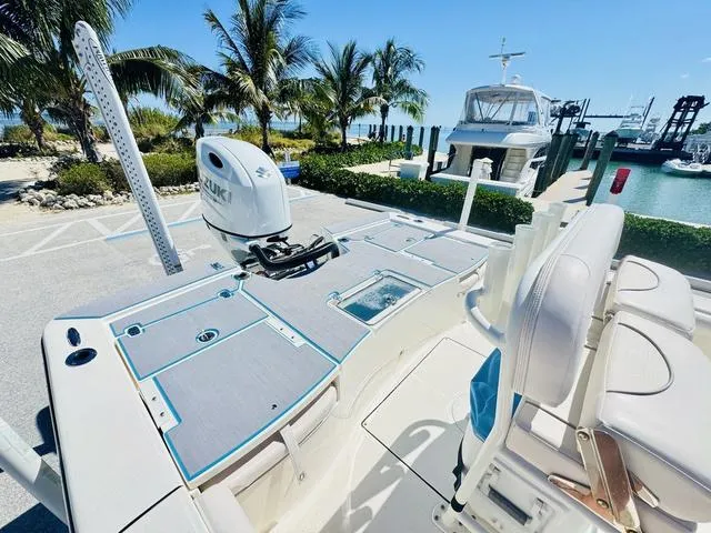 Slide: The Image of 2021 Sea Born FX24 boat docked near palm trees and marina. - 6