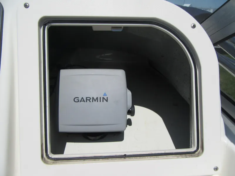 Slide: The Image of Garmin device inside 2002 Fish Hawk 210 WA boat compartment. - 16