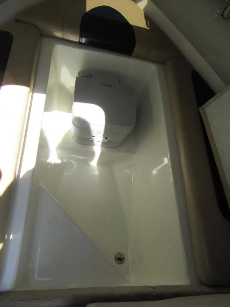 Slide: The Image of 2002 Fish Hawk 210 WA boat interior with seating and storage area. - 25