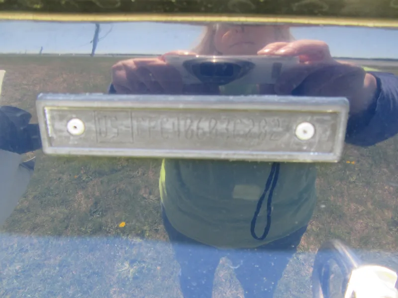 Slide: The Image of Reflection on Fish Hawk 210 WA 2002 boat hull with identification plate. - 26