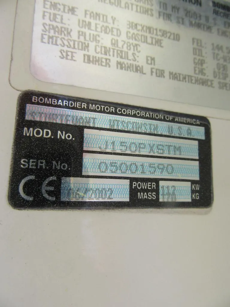 Slide: The Image of Bombardier motor label on 2002 Fish Hawk 210 WA boat, displaying model and serial numbers. - 27