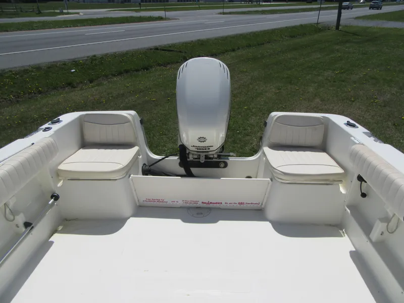 Slide: The Image of 2002 Fish Hawk 210 WA boat interior with seating and outboard motor. - 5