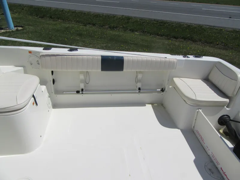 Slide: The Image of 2002 Fish Hawk 210 WA boat interior with white seating and clean deck. - 6