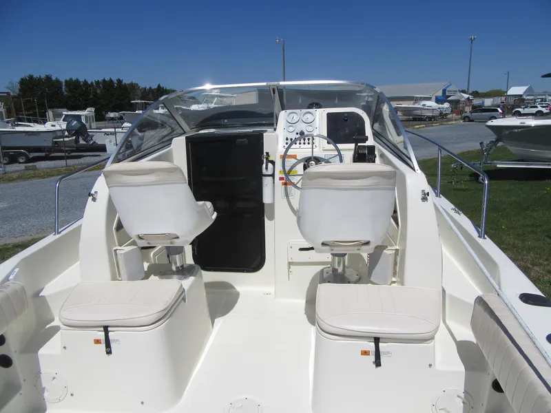 Slide: The Image of 2002 Fish Hawk 210 WA boat interior with dual seats and control panel. - 8