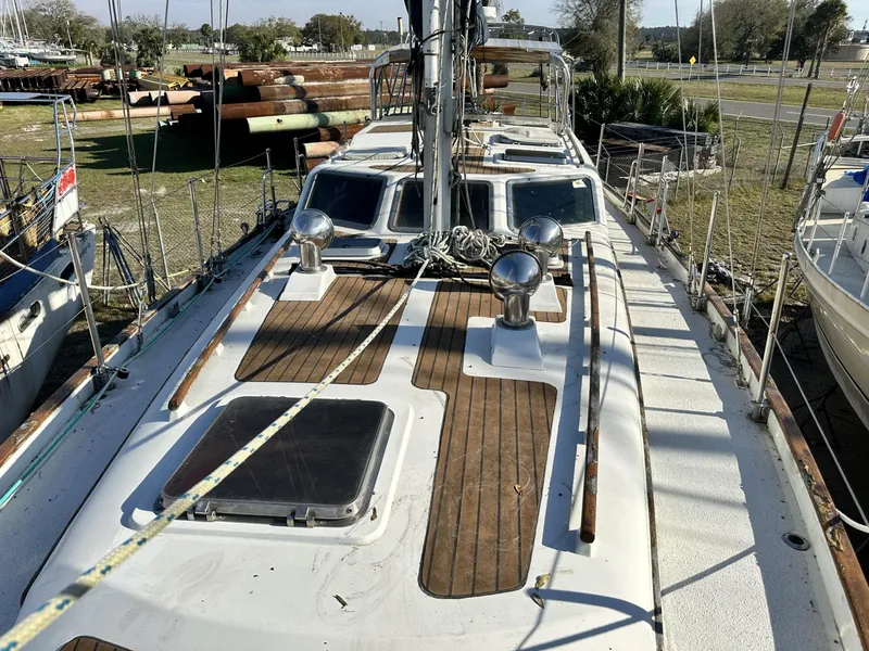 Slide: The Image of 1986 Slocum 43 sailboat deck with wooden accents and metal fixtures. - 0