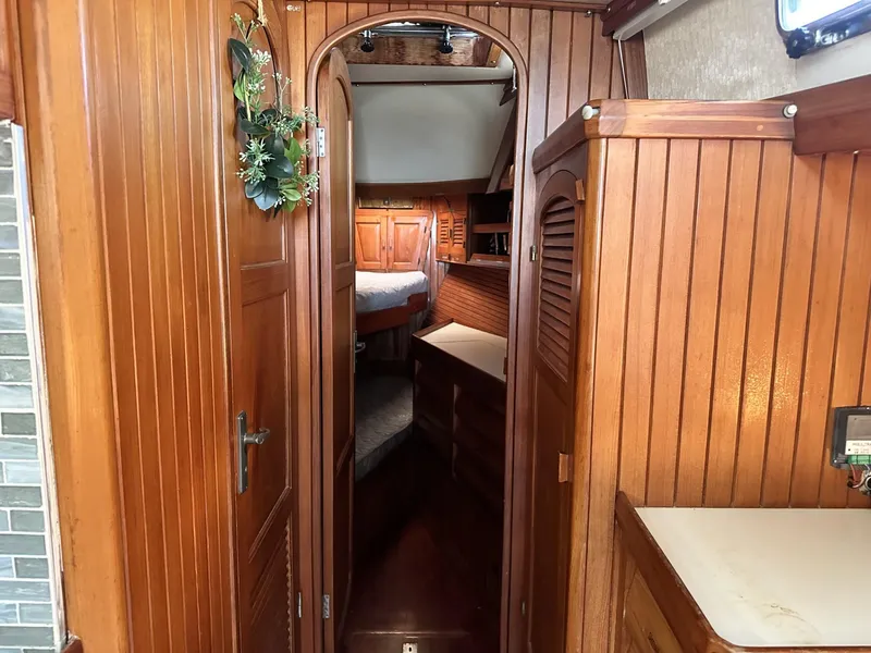 Slide: The Image of Interior of 1986 Slocum 43 sailboat with wooden paneling and cozy cabin. - 17
