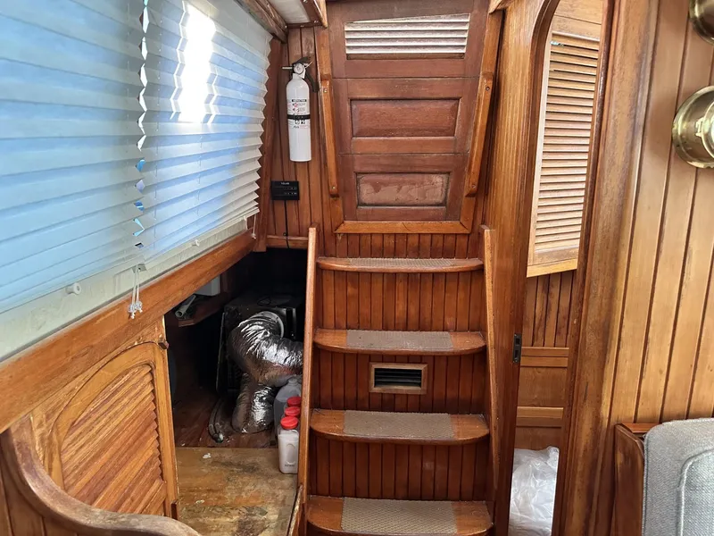 Slide: The Image of Interior of 1986 Slocum 43 sailboat with wooden stairs and nautical decor. - 19
