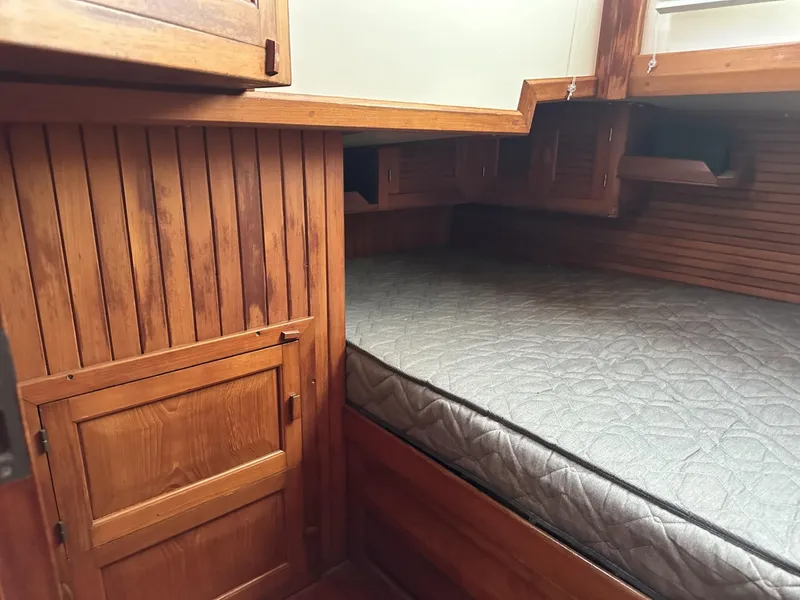 Slide: The Image of Wood-paneled cabin interior with a bed, Slocum 43, 1986 model. - 21