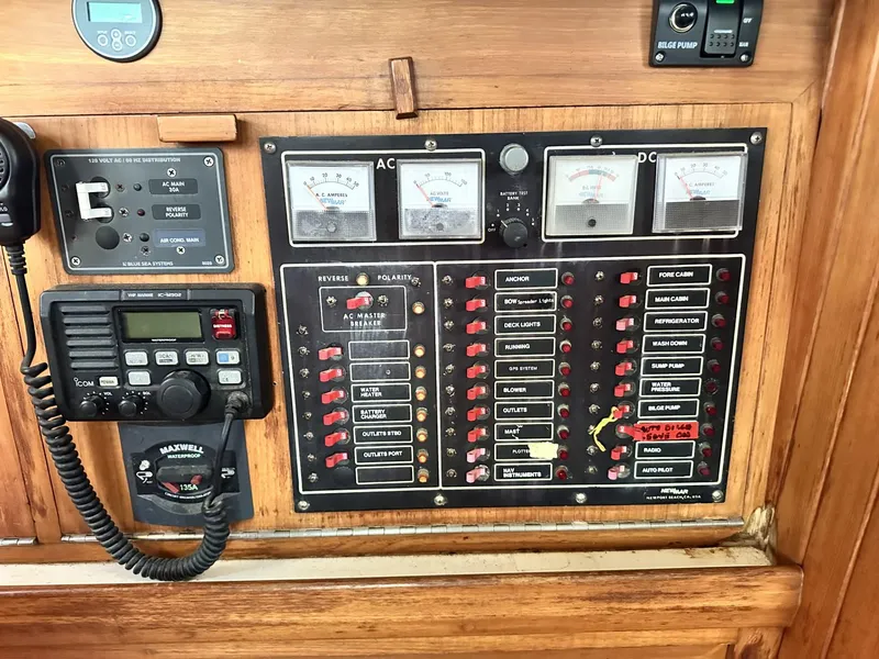Slide: The Image of Electrical control panel on a 1986 Slocum 43 sailboat, featuring AC/DC meters and communication equipment. - 26