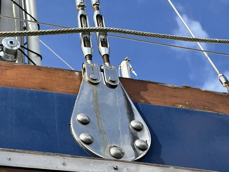 Slide: The Image of Close-up of rigging hardware on a 1986 Slocum 43 sailboat against a blue sky. - 28