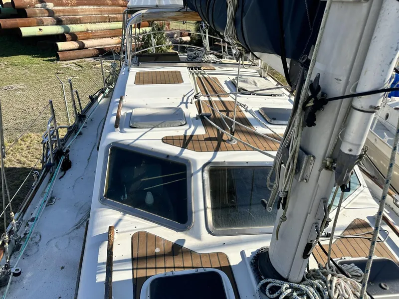 Slide: The Image of 1986 Slocum 43 sailboat deck with wooden accents and rigging. - 3