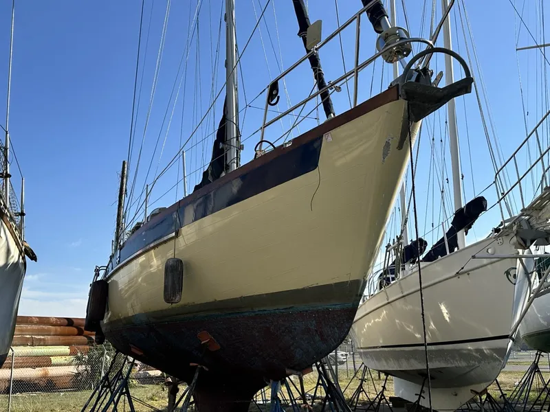 Slide: The Image of 1986 Slocum 43 sailboat on dry dock, blue sky background. - 36