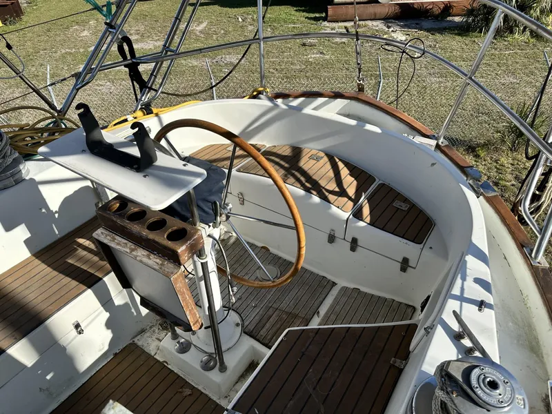 Slide: The Image of Cockpit of 1986 Slocum 43 sailboat with wooden wheel and seating. - 5