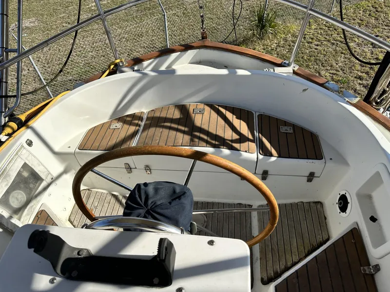 Slide: The Image of Cockpit of 1986 Slocum 43 sailboat with wooden wheel and seating. - 6