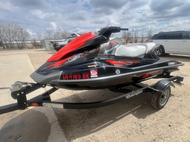 Slide: The Image of 2017 Yamaha WaveRunner VX Deluxe on trailer, parked outdoors under cloudy sky. - 2